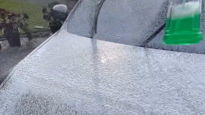 Snow foam being laid onto the bonnet of a car on an Auckland driveway by Titan Auto Detailing